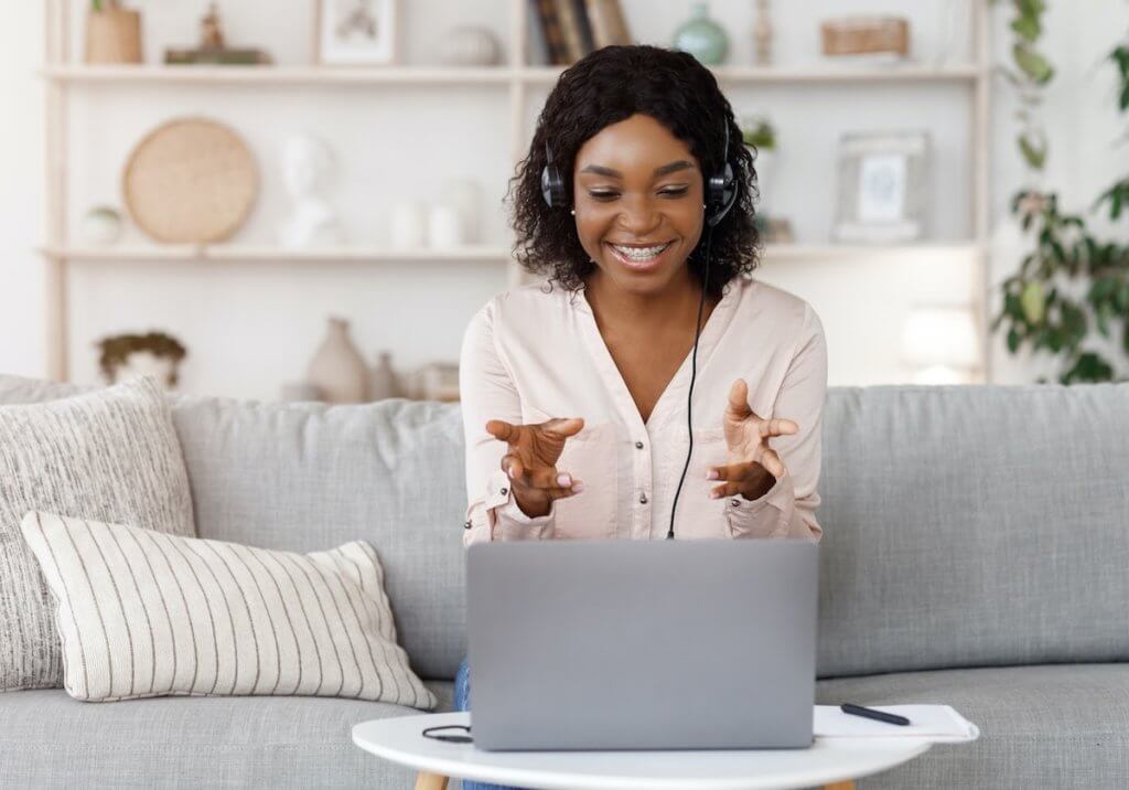 A woman sitting on a couch and virtual networking