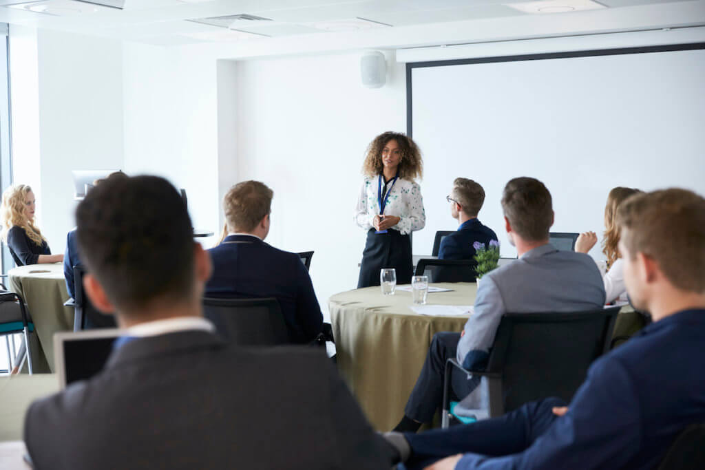 A woman presents her pitch before an audience