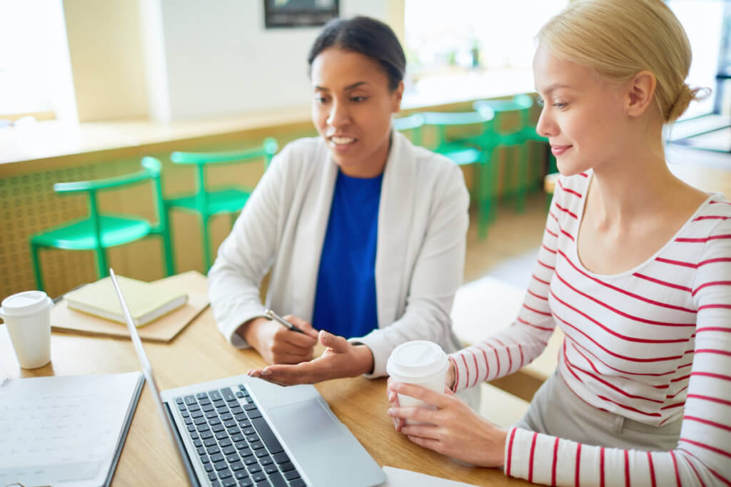 Two women business networking in coffee shop