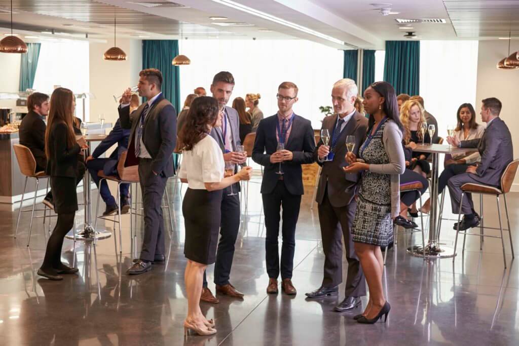 Room full of business people talking at a local networking group